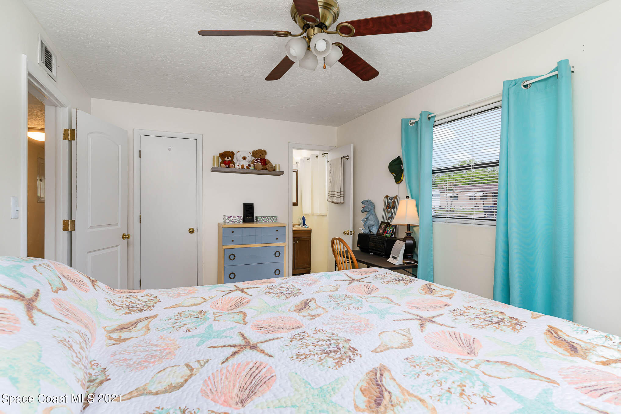 2285 Dolphin Road Titusville, FL 32780 - Photo 23 of 27 a bed room with a bed and a chandelier