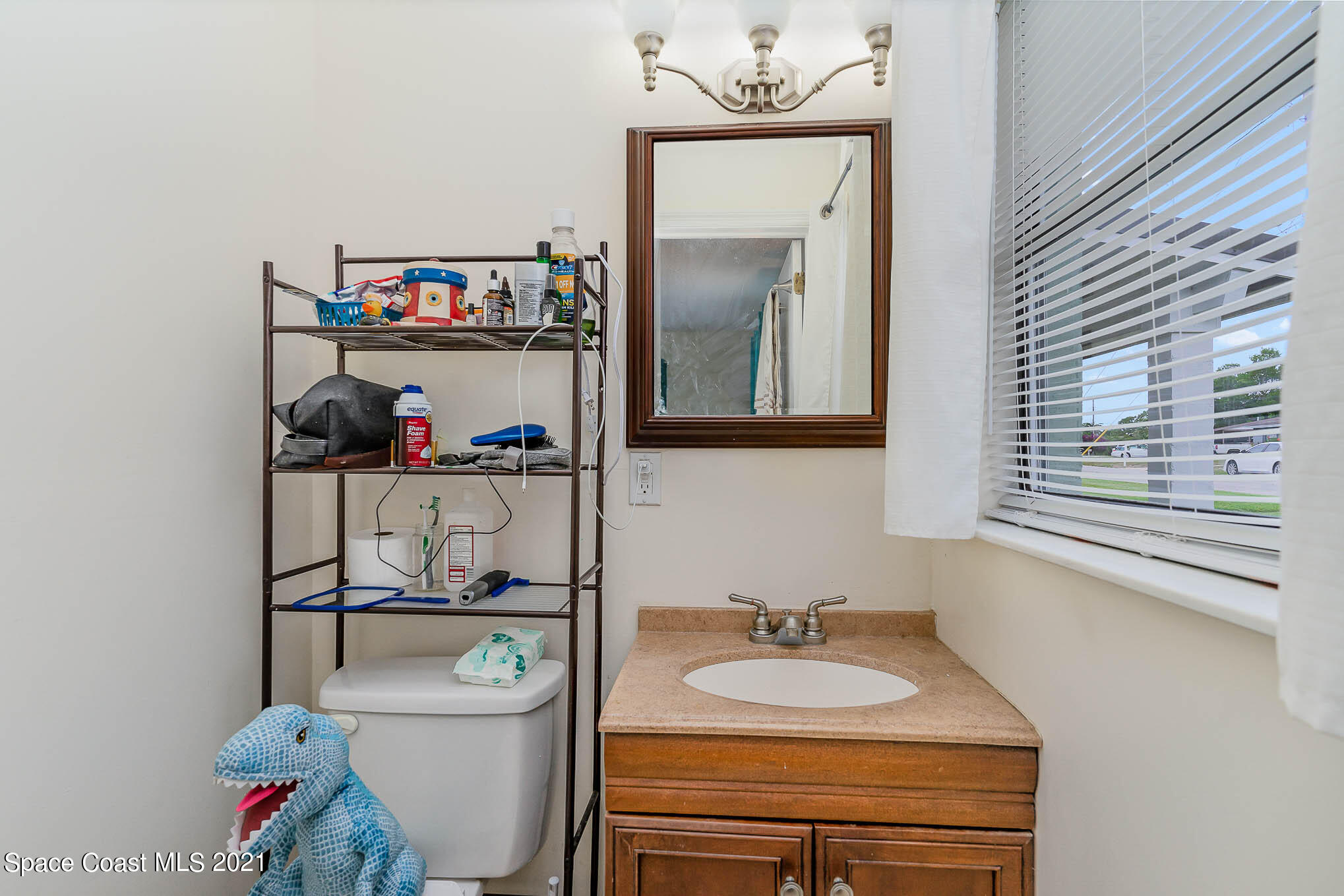 2285 Dolphin Road Titusville, FL 32780 - Photo 25 of 27 a bathroom with a sink vanity mirror and toilet