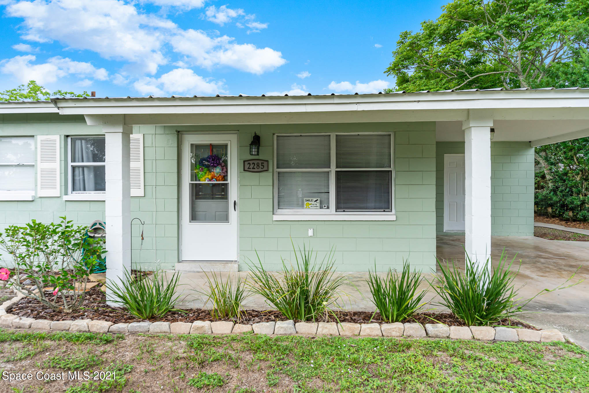 2285 Dolphin Road Titusville, FL 32780 - Photo 4 of 27 a front view of a house with a garden
