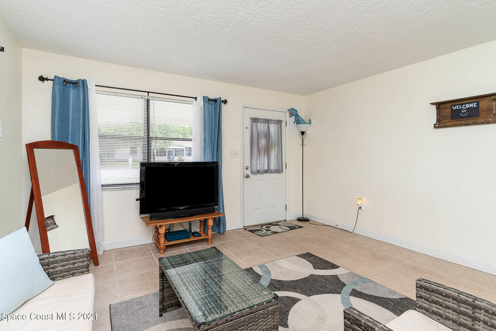 2285 Dolphin Road Titusville, FL 32780 - Photo 10 of 27 a living room with furniture and a flat screen tv