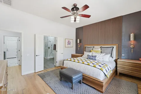 a bedroom with a bed and a chandelier