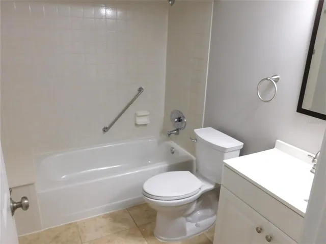 a white toilet sitting next to a bath tub