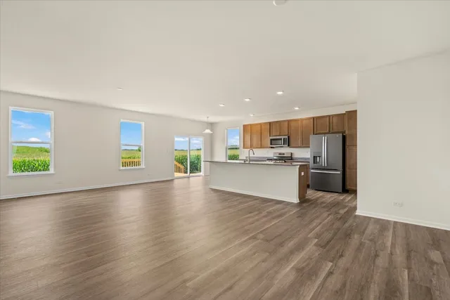 a view of kitchen with kitchen island wooden floor and window
