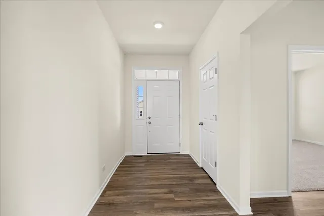 a view of a hallway with wooden floor