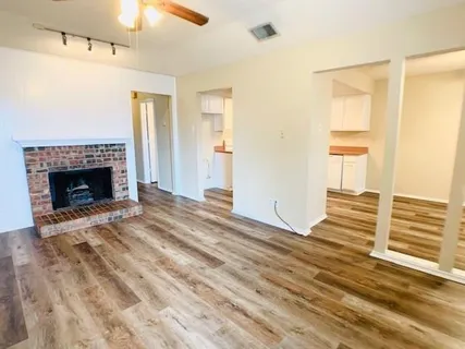 a view of livingroom with wooden floor and a fireplace
