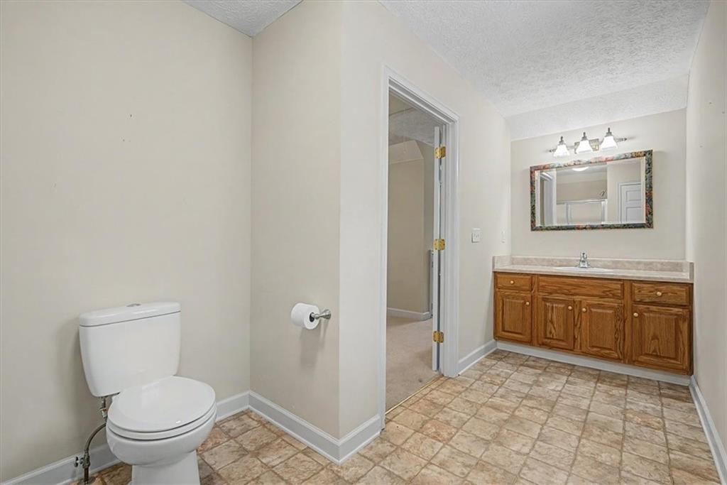 1136 Cole Lake Road Dallas, GA 30157 - Photo 43 of 72 a spacious bathroom with a toilet sink and mirror
