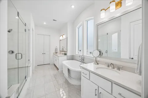 a bathroom with a double vanity sink mirror double and shower