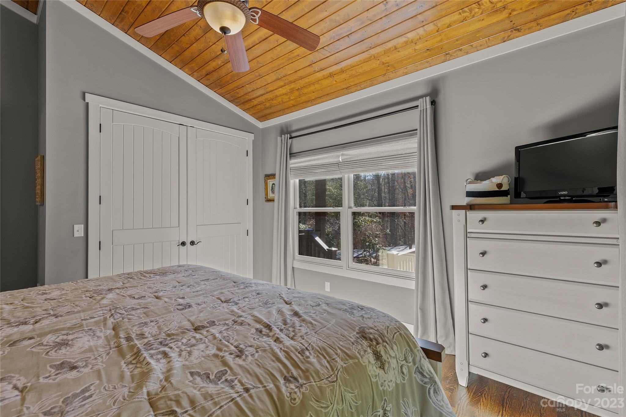 160 Deer Run Road Sapphire, NC 28774 - Photo 34 of 42 a bedroom with a bed and a flat screen tv