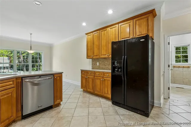 a kitchen with granite countertop a refrigerator and a sink