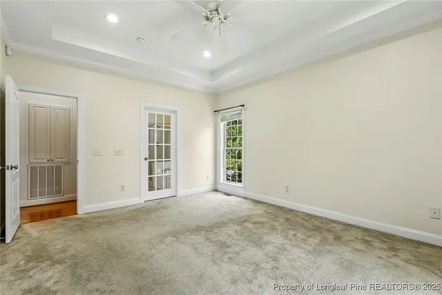 an empty room with windows and closet