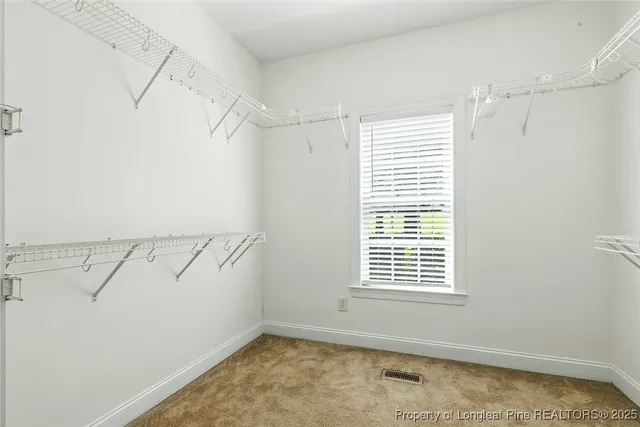 a view of a room with rack on the wall and a window