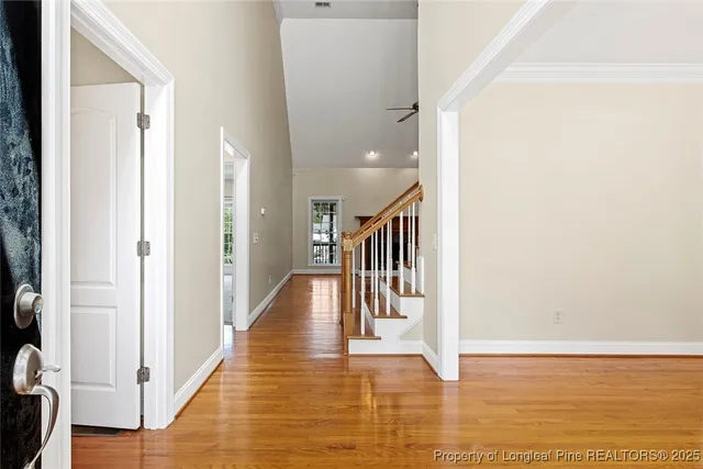 a view of entryway and hall with wooden floor