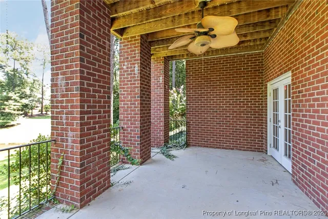 a front view of house with yard and trees in the background
