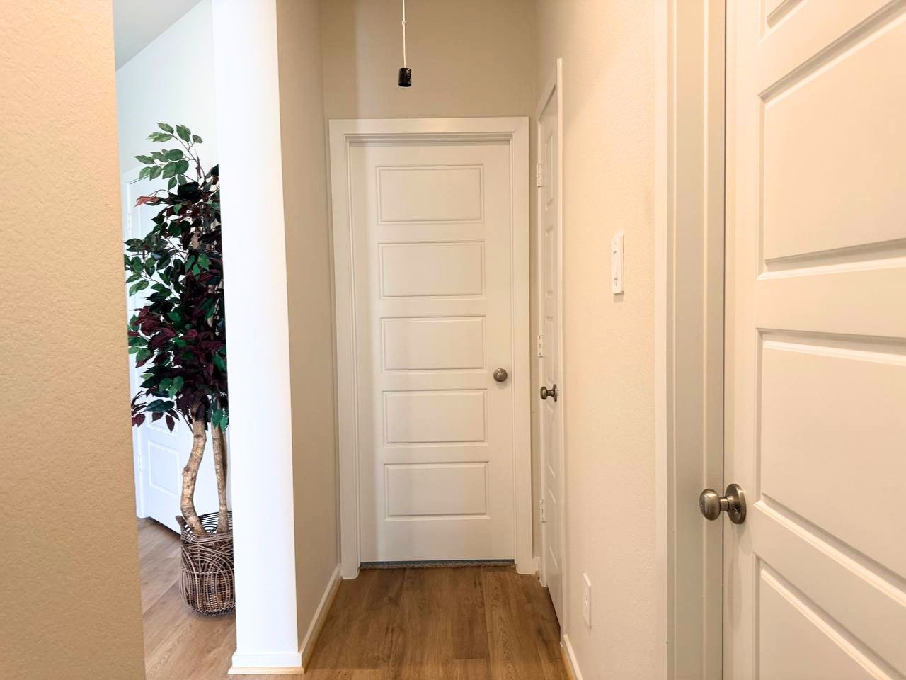 16246 Parish Pointe Court Conroe, TX 77302 - Photo 25 of 32 a view of a hallway with wooden floor and closet