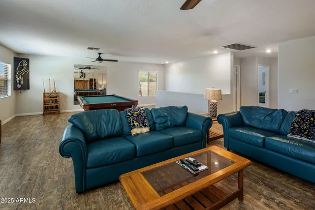 a room with pool table and windows