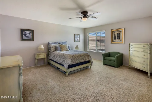 a spacious bedroom with a bed and wooden floor
