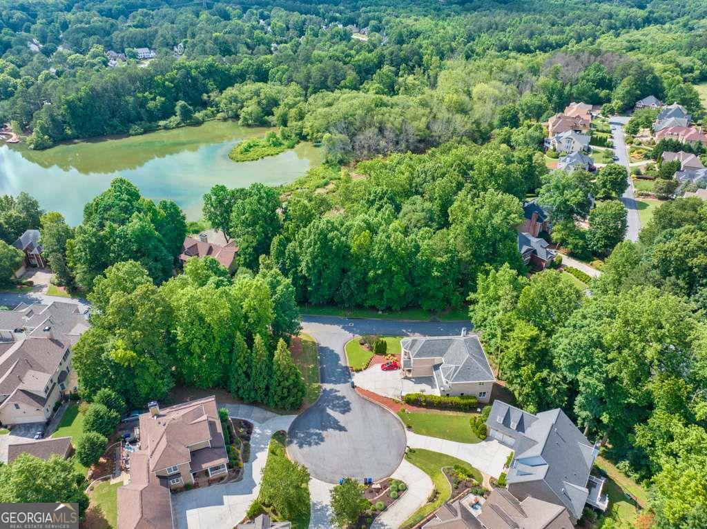 an aerial view of a house with a garden and lake view
