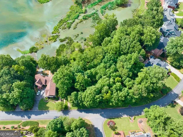 an aerial view of a house with a yard