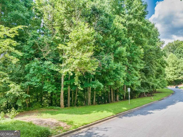 an aerial view of a house with a garden and lake view