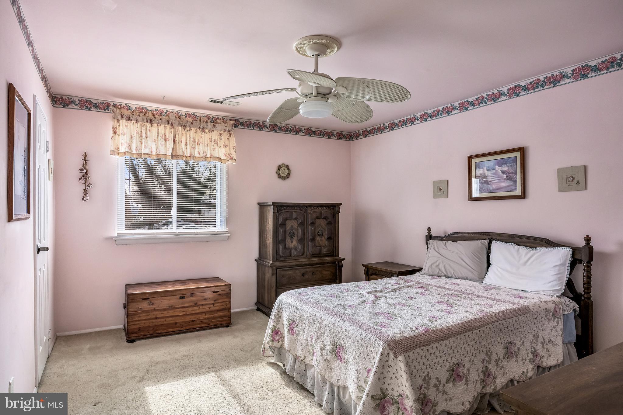 411 Stiles Avenue, Unit A2 Maple Shade, NJ 08052 - Photo 12 of 26 a bedroom with a bed and a chandelier
