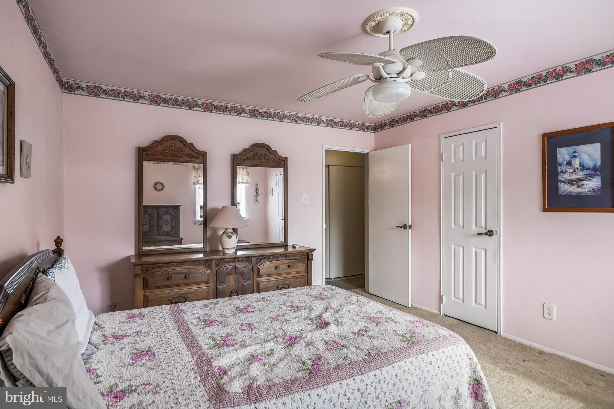 411 Stiles Avenue, Unit A2 Maple Shade, NJ 08052 - Photo 14 of 26 a bedroom with a large bed and a chandelier