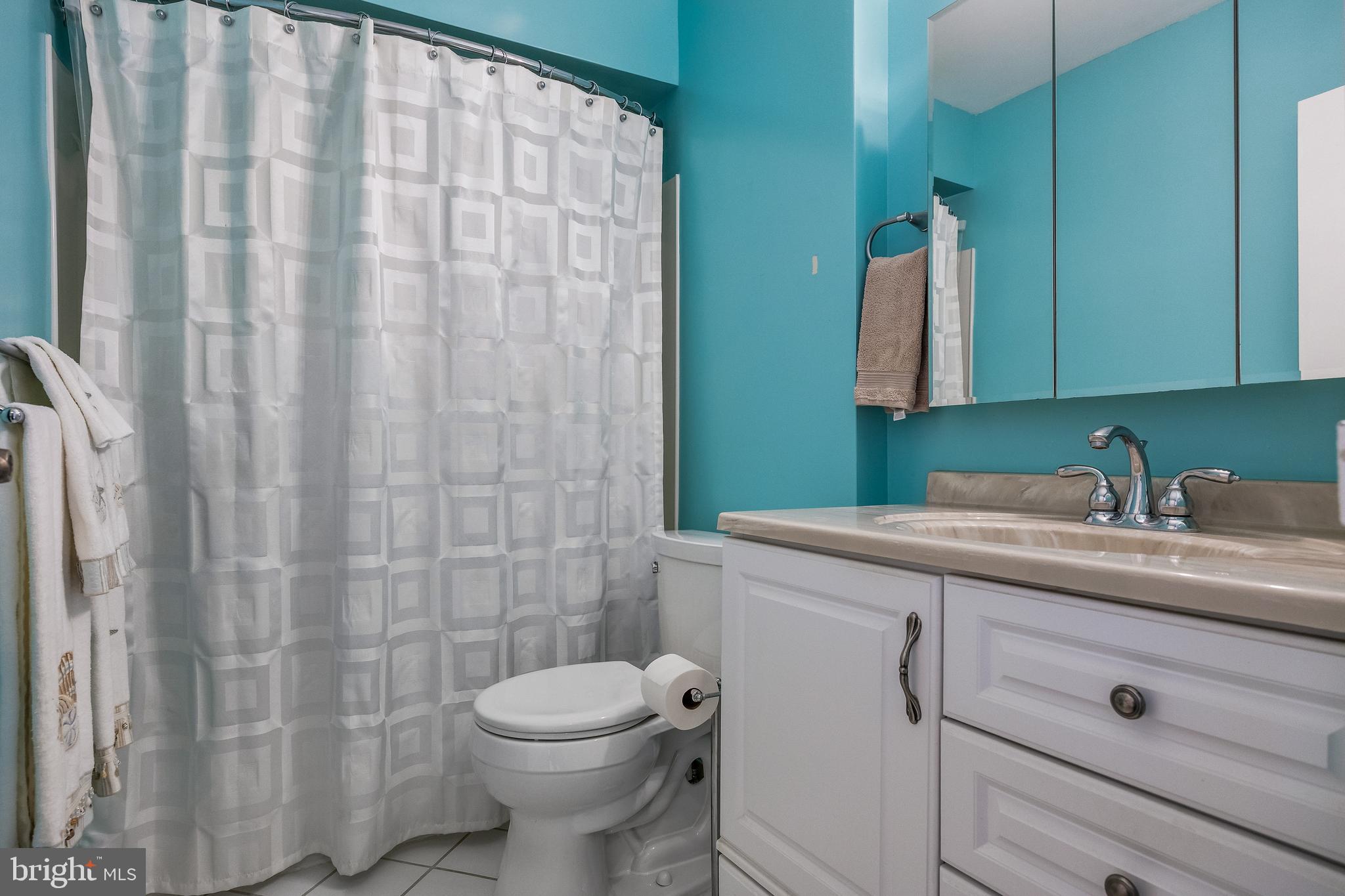 411 Stiles Avenue, Unit A2 Maple Shade, NJ 08052 - Photo 16 of 26 a bathroom with a granite countertop sink and a mirror