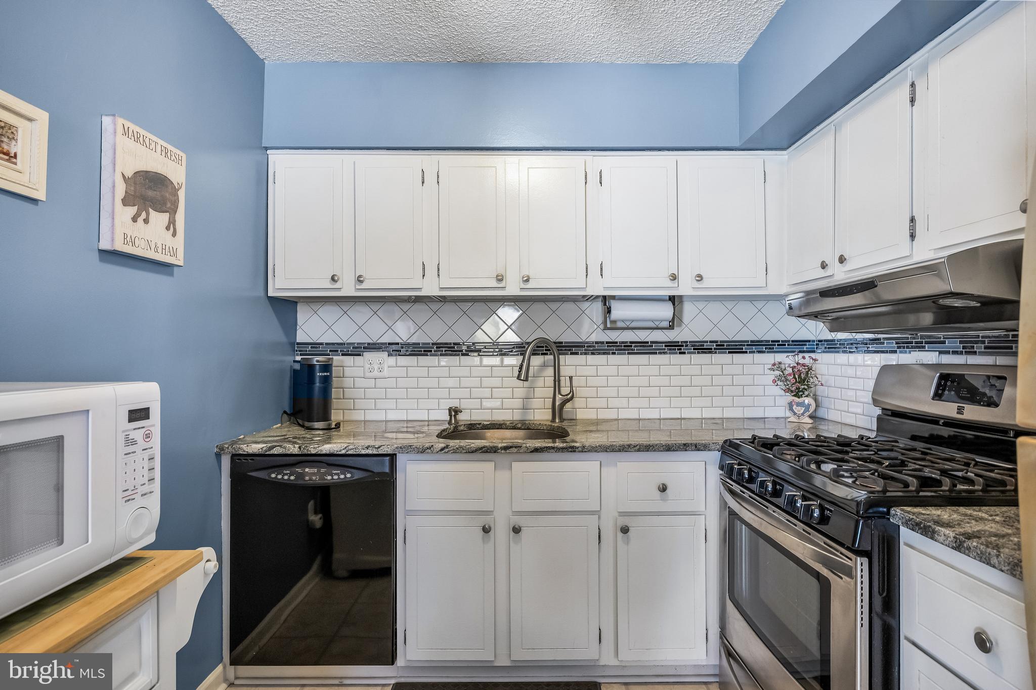 411 Stiles Avenue, Unit A2 Maple Shade, NJ 08052 - Photo 9 of 26 a kitchen with cabinets appliances and a wooden floor