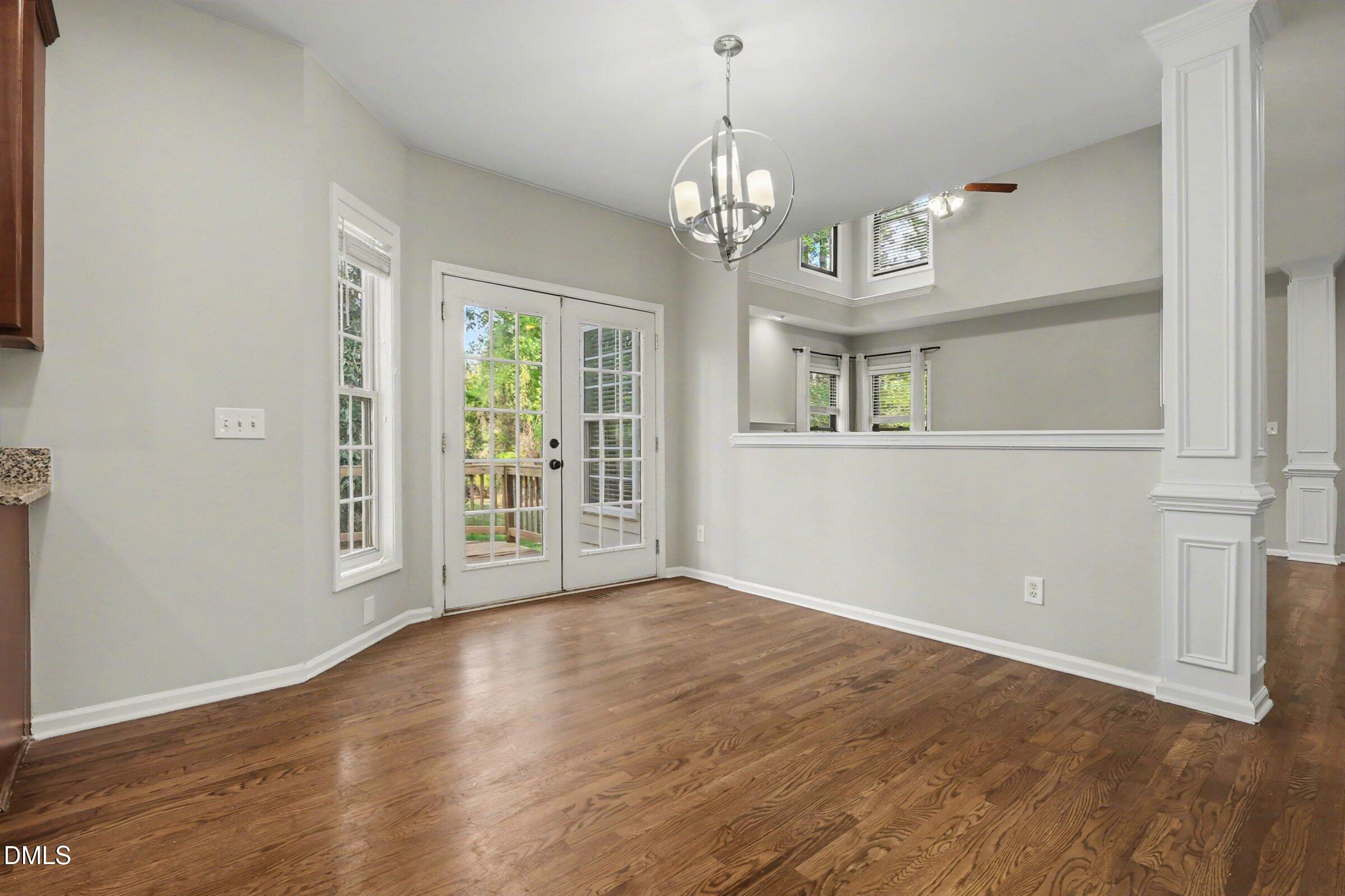 1001 Denfield Court Raleigh, NC 27615 - Photo 15 of 44 a view of an empty room with wooden floor and a window