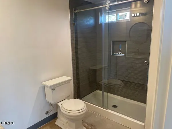 a bathroom with a shower and a toilet