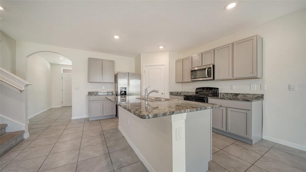 12732 Lateral Root Drive Sarasota, FL 34238 - Photo 13 of 76 a kitchen with a sink a stove top oven and cabinets