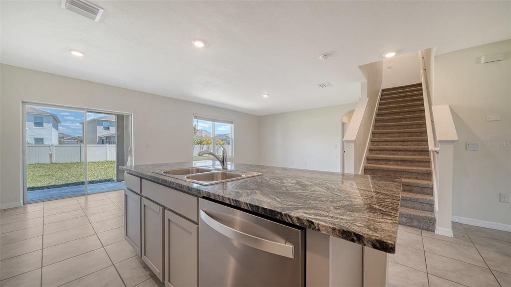 12732 Lateral Root Drive Sarasota, FL 34238 - Photo 15 of 76 a kitchen with granite countertop a sink and a wooden floor