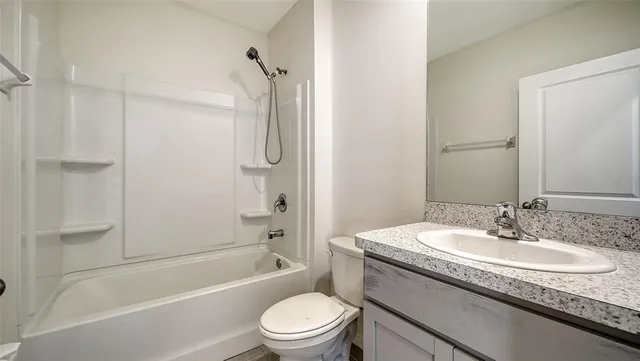 a bathroom with a shower and a sink