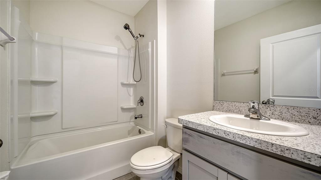 12732 Lateral Root Drive Sarasota, FL 34238 - Photo 20 of 76 a bathroom with a granite countertop sink toilet and shower