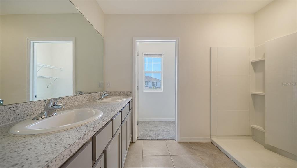 12732 Lateral Root Drive Sarasota, FL 34238 - Photo 27 of 76 a bathroom with a sink and a mirror