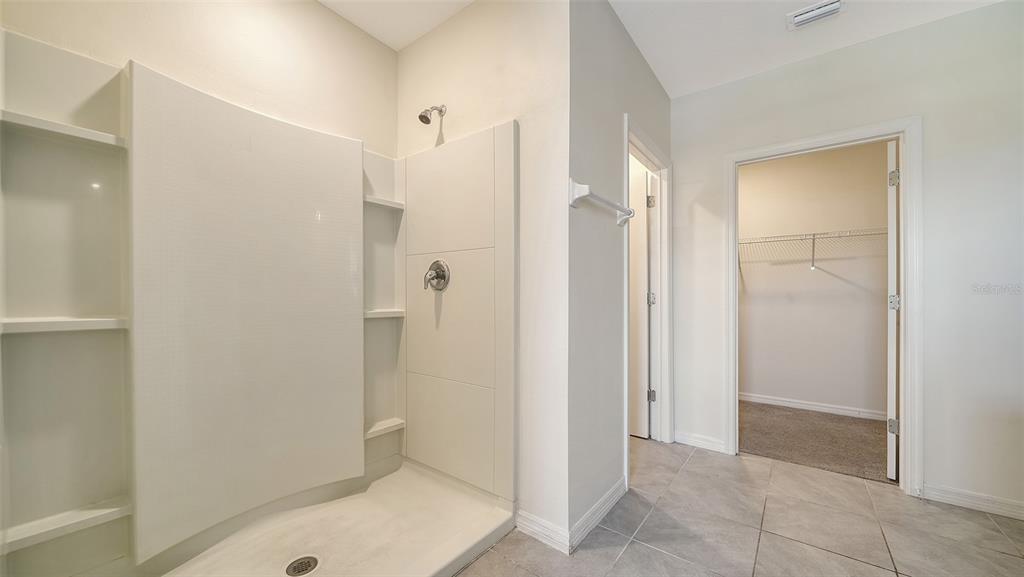 12732 Lateral Root Drive Sarasota, FL 34238 - Photo 28 of 76 a bathroom with a shower and a sink