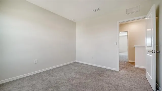 an aerial view of a house with a yard and lake view
