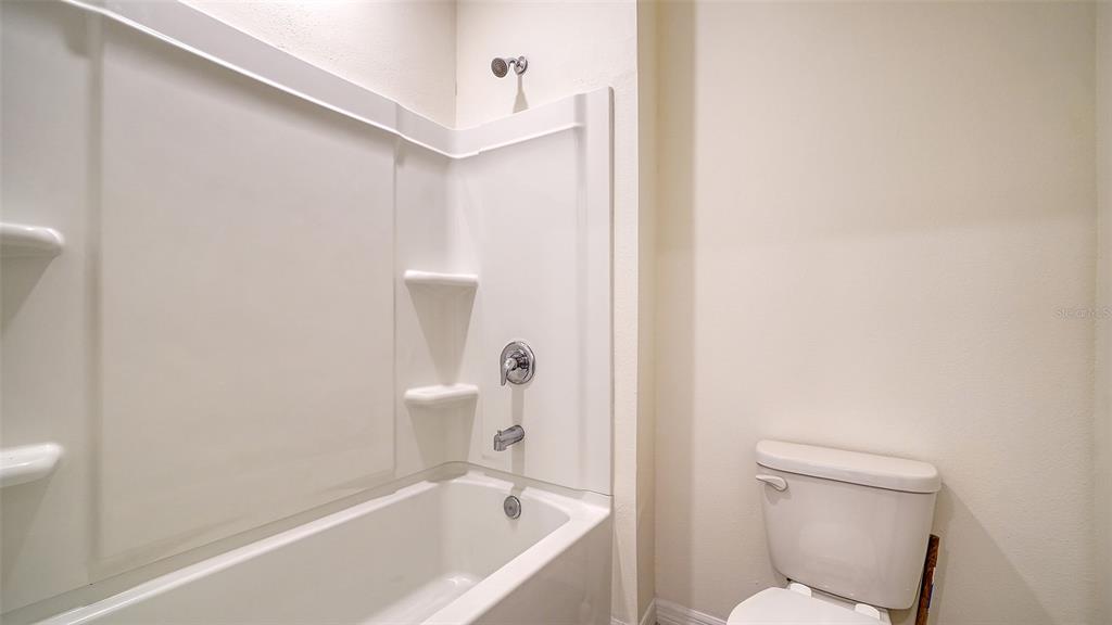 12732 Lateral Root Drive Sarasota, FL 34238 - Photo 38 of 76 a white toilet sitting next to a bathtub