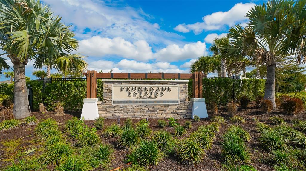 12732 Lateral Root Drive Sarasota, FL 34238 - Photo 45 of 76 a view of a sign board with potted plants and palm trees
