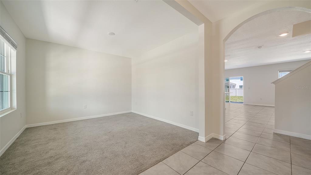 12732 Lateral Root Drive Sarasota, FL 34238 - Photo 5 of 76 an empty room with entrance and windows