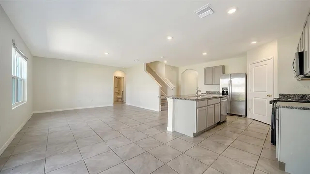 a kitchen with a sink a stove top oven and cabinets