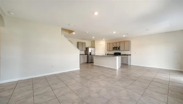 a kitchen with stainless steel appliances granite countertop a sink and a refrigerator