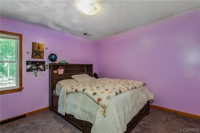 a bedroom with pink walls and pink walls