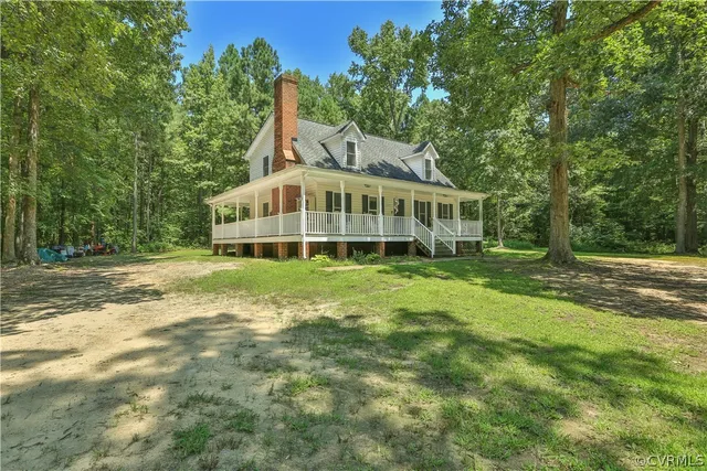 a view of a house with a backyard and a patio