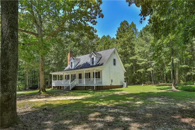 a view of a house with yard and sitting area
