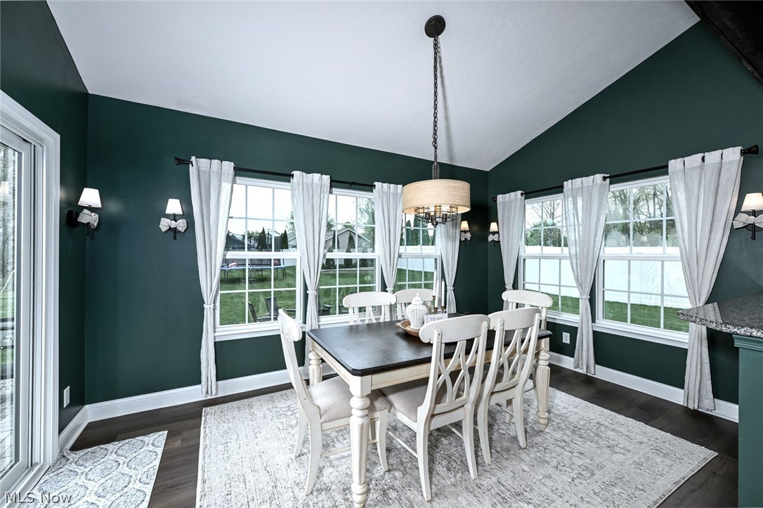 3021 Stonehurst Road Uniontown, OH 44685 - Photo 19 of 48 *MORNING ROOM W/WALLS OF WINDOWS, VAULTED CEILING, BEAMED ENTRY, CHANDELIER & ADDED SCONCE LIGHTING NEAR BREAKFAST BAR W/SLIDERS TO THE BACK YARD ~