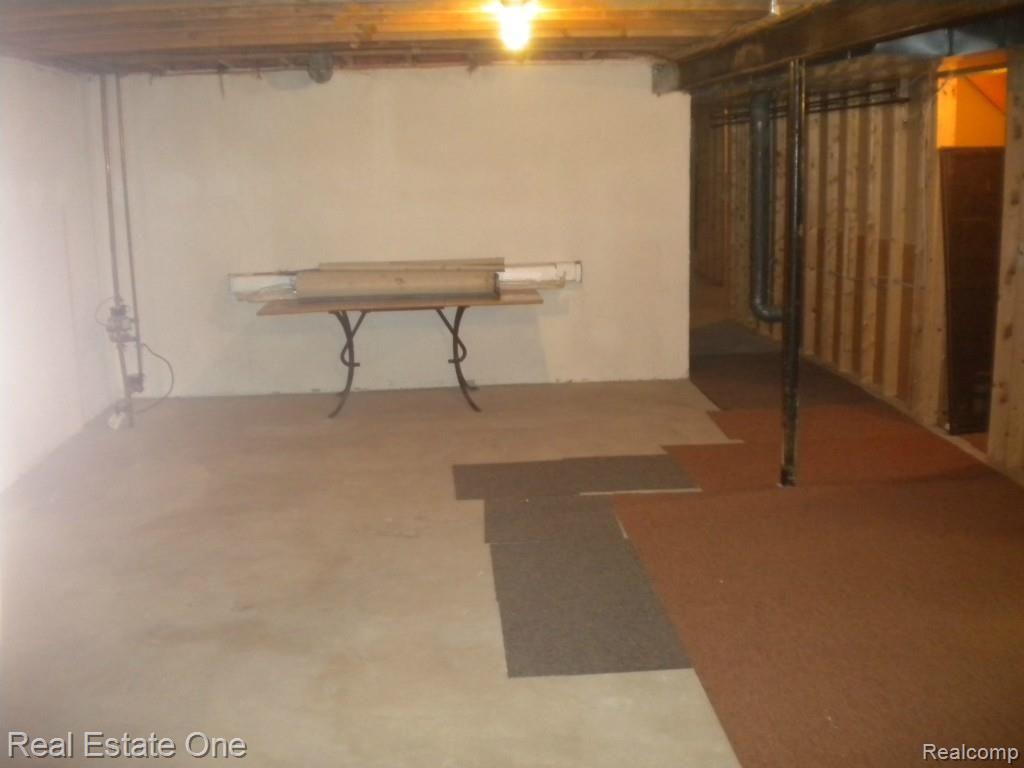 36615 Valley Ridge Drive Farmington, MI 48331 - Photo 45 of 51 Huge extra room in basement and done that hall to the right to util area
