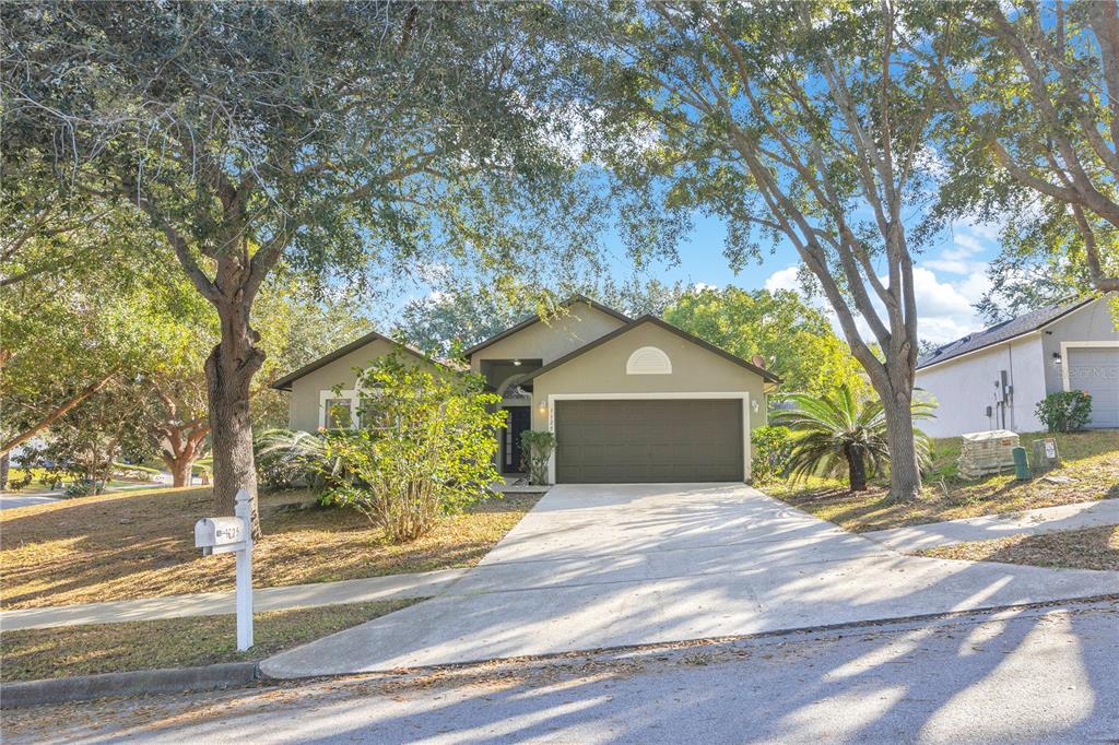 1125 Blackjack Ridge Street Minneola, FL 34715 - Photo 1 of 1 a front view of a house with a yard and garage