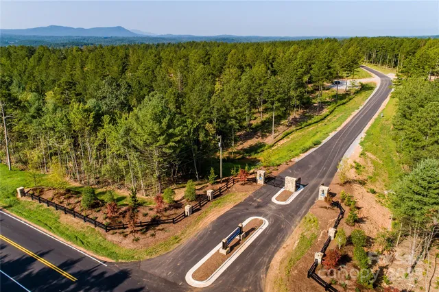 a view of a swimming pool with a patio and a yard