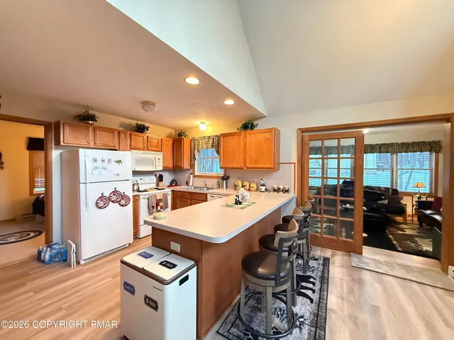 a front view of house with yard and trees in the background