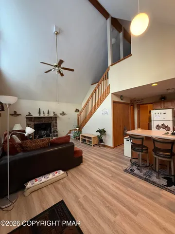 a living room with furniture and a floor to ceiling window
